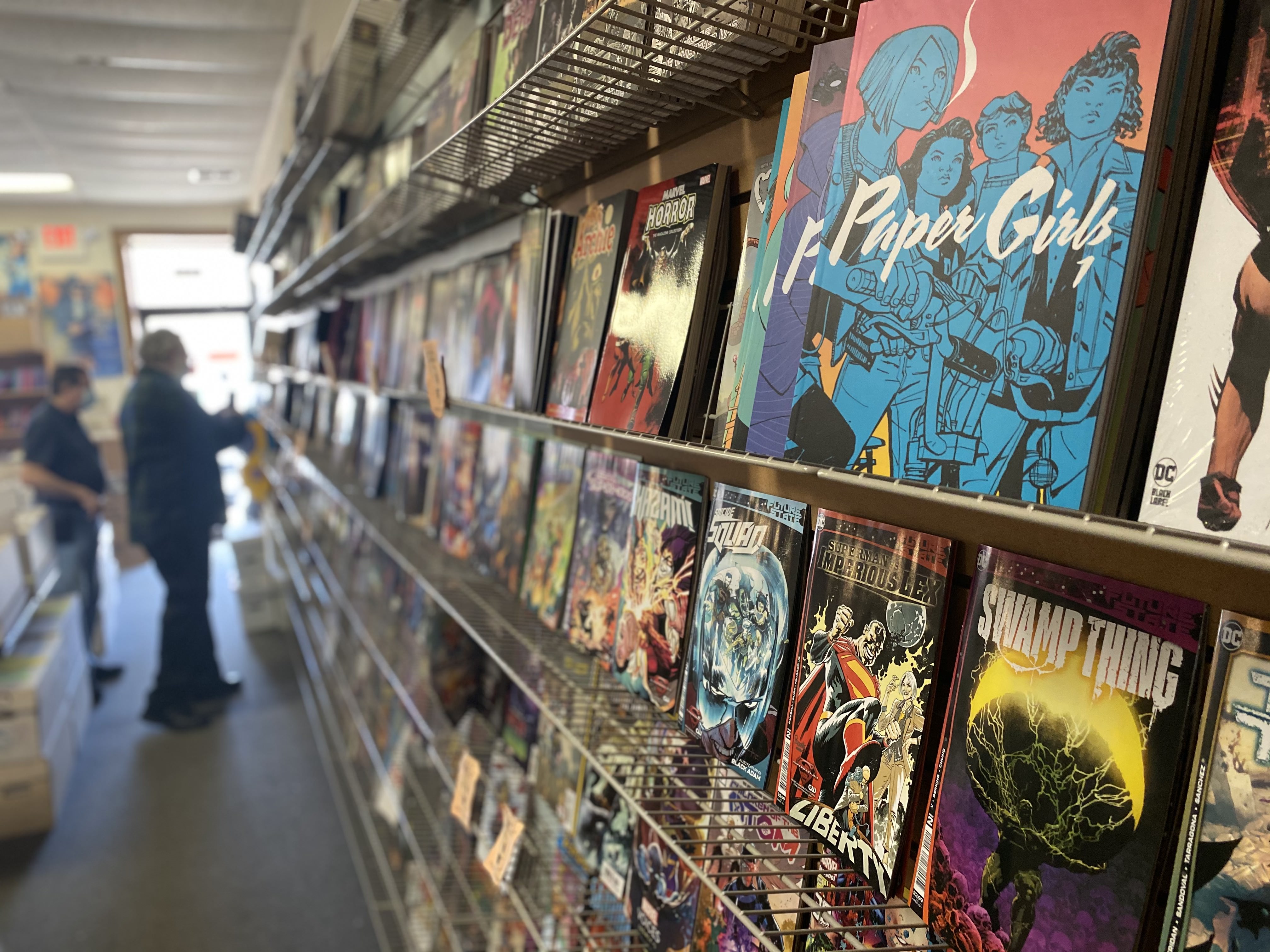Comics on a shelf inside the store.